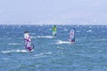 Windsurfers on the sea waves on a windy autumn day in the Amur Bay in Vladivostok