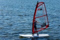 Windsurfing on Baltic Sea. Unidentifiable Windsurfer Surfing The Wind On Waves