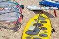 Windsurfing board with sail lying on the sand Royalty Free Stock Photo