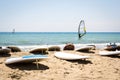 Windsurfing board with sail lying on the sand