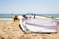 Windsurfing board with sail lying on the sand Royalty Free Stock Photo