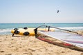 Windsurfing board with sail lying on the sand Royalty Free Stock Photo