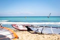 Windsurfing board with sail lying on the sand Royalty Free Stock Photo