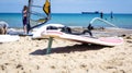 Windsurfing board with sail lying on the sand Royalty Free Stock Photo