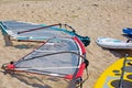 Windsurfing board with sail lying on the sand Royalty Free Stock Photo