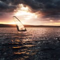 Windsurfing on a lake at sunset