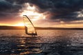 Windsurfing on a lake at sunset