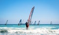 Windsurfing sails on the blue sea