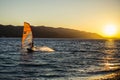 Windsurfer and sun, water and mountains
