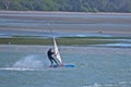 windsurfing in Tamaki river with low tide mudflats in background Royalty Free Stock Photo
