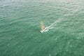 windsurfing, wind surf. Extreme sport in tropical blue ocean, clear water. Aerial views, top view of windsurfing on the waves of Royalty Free Stock Photo