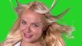 Windswept blonde woman smiling on green screen