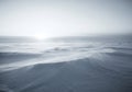 Windswept snow dunes in a vast, featureless landscape create an Royalty Free Stock Photo