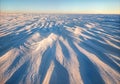 Windswept Snow Formations Sastrugi with Sculptural Ridge Patterns and Strong Side Lighting Royalty Free Stock Photo