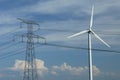 A windturbine close to a electric pylon Royalty Free Stock Photo