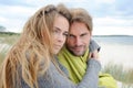 Windy autumn days relaxing on coast - sand dune, beach, beautiful couple Royalty Free Stock Photo