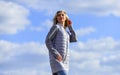 Windy day. Girl jacket cloudy sky background. Woman fashion model outdoors. Woman enjoying cool weather. Freshness of Royalty Free Stock Photo