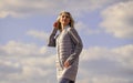 Windy day. Girl jacket cloudy sky background. Woman fashion model outdoors. Woman enjoying cool weather. Freshness of Royalty Free Stock Photo