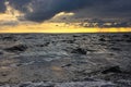 Windy seascape at sunset with water waves and cloudy sky in the background Royalty Free Stock Photo