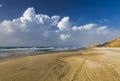 Windy sunny day on the beach. Stormy sea, strong wind, white foam on the waves. Netanya, Israel, Mediterranean sea. Overcast Royalty Free Stock Photo