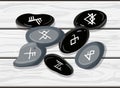 Rune stones with encrypted glyphs on the wooden table, vector