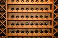 Wine. Luxury home wine cellar. Bottles of wine stacked end on in a large wine rack in a winery. horizontally, diagonal Wine Rack Royalty Free Stock Photo