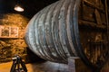 Wine barrel in cellar. Cavernous wine cellar with stacked oak barrels for maturing red wine Royalty Free Stock Photo