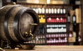 Wine barrel with copper tap and bottles of wine on the shelves at the background