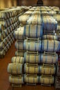 Wine barrels in the antique cellar. Cavernous wine cellar with stacked oak barrels for maturing red wine. Royalty Free Stock Photo