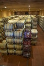 Wine barrels in the cellar of the winery. Wine barrels in wine vaults. Producer: Antinori Bolgheri, Tuscany, Italy