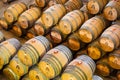 Wine barrels full of wine in storage on a wine farm.