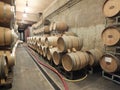 Wine barrels stacked in the cellar of the winery. Royalty Free Stock Photo
