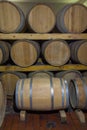 Wine barrels stacked in a old cellar at winery Royalty Free Stock Photo