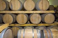 Wine barrels stacked in a old cellar at winery Royalty Free Stock Photo