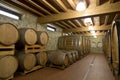 Wine barrels stacked in the old cellar of the winery, Royalty Free Stock Photo