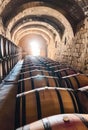 Wine barrels stacked in the old cellar of the winery. Photo of wine barrels in an ancient winery Royalty Free Stock Photo