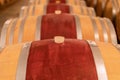 Wine barrels stacked in the old cellar of the winery. Royalty Free Stock Photo