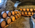 Wine barrels in wine-vaults in order. Wine barrels stacked in the old cellar Royalty Free Stock Photo