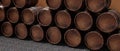 Wine beer casks stacked in a dark cellar. Oak wood barrel for rum bourbon storage. 3d render