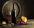 Wine bootle and glass with food on wooden table Royalty Free Stock Photo