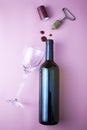 wine bottle cork corkscrew shrink wrap glass and drops of red wine on pink background Royalty Free Stock Photo