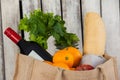 Wine bottle, fruits and vegetables with bread loaf in grocery bag Royalty Free Stock Photo