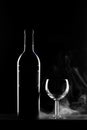 Wine Bottle with Glass on black background with smoke Royalty Free Stock Photo
