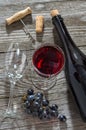 Wine bottle, glass of wine, bunch of blue grapesand and corkscrew Royalty Free Stock Photo