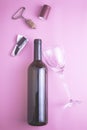 wine bottle glass glass stopper corkscrew chocolate and shrink cap on pink background Royalty Free Stock Photo