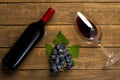 Wine bottle glass grapes on wooden background. Top view with copy space Royalty Free Stock Photo