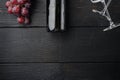 Wine Bottle and glass of Red wine with ripe grapes, on black wooden table background, top view flat lay, with copy space for text Royalty Free Stock Photo