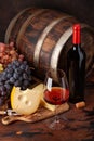 Wine bottle, grapes, cheese and glass of red wine Royalty Free Stock Photo