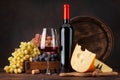 Wine bottle, grapes, cheese and glass of red wine Royalty Free Stock Photo