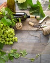 Wine bottle and grapes on wooden table. Top view with space for Royalty Free Stock Photo